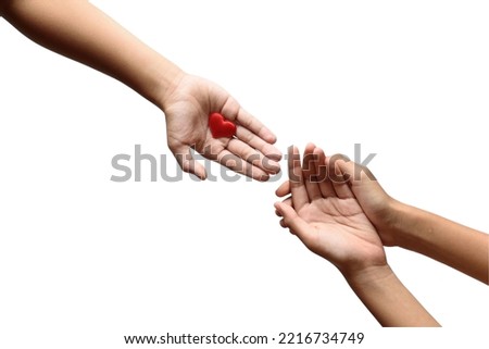 Close up of kid's hand playing with hearts on a white background