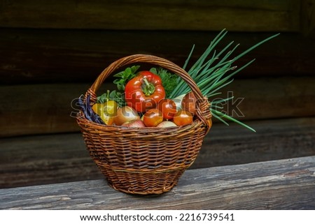 Fresh Vegetable And Food in Basket .Fresh vegetables in basket on wooden background .Composition with vegetables and fruits in wicker basket