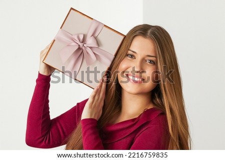 Holiday present for birthday, baby shower, wedding or luxury beauty box subscription delivery, happy woman holding a wrapped pink gift on white background