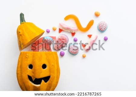 Trick or treat halloween candy coming from a pumpkin head