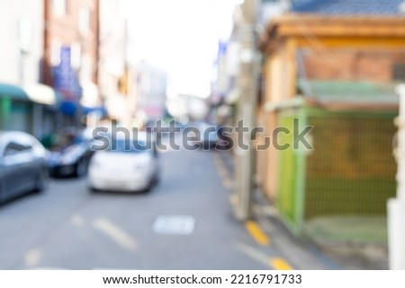 Blurred view of Seoul street with shops, roads, cars and buildings. Can be used as background. De focused image of capital of south Korea.
