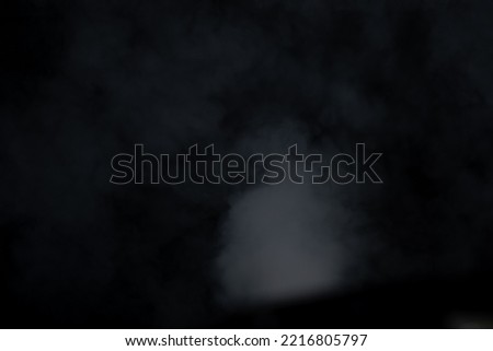 smoke floating on a black background