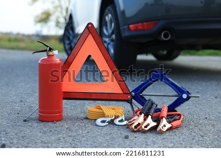 Emergency warning triangle and car safety equipment outdoors Royalty-Free Stock Photo #2216811231