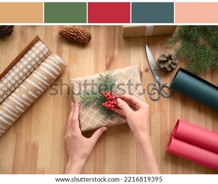 Woman making Christmas gift at table, top view. Different color patterns