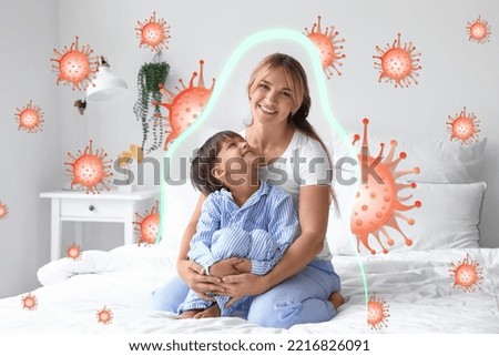 Little boy with his mother sitting on bed. Concept of strong immunity Royalty-Free Stock Photo #2216826091