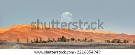 General view of the Merzouga hotels district with full moon - Merzouga, Sahara, Morocco "Elements of this image furnished by NASA" Royalty-Free Stock Photo #2216854949