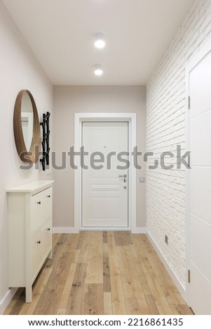 White entrance door inside an apartment in a modern interior Royalty-Free Stock Photo #2216861435