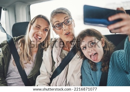 Phone, selfie and family in a car with silly faces driving to a holiday destination together. Grandmother, mother and girl child taking picture on smartphone on the route to vacation resort in Canada