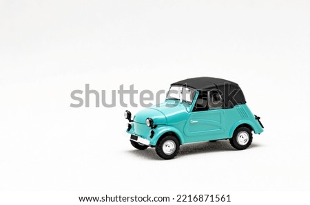An old toy model of a retro car. Isolate on a white background