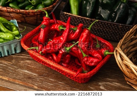 Rustic Agriculture Food Photography of Fresh Red Spicy Chili Pepper Vegetables Inside a Produce Harvest Basket