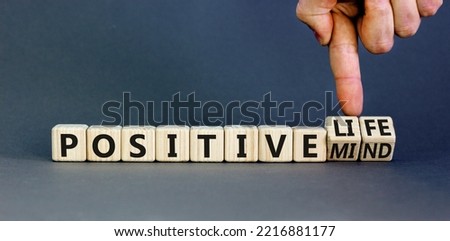 Positive mind and life symbol. Concept words Positive mind or Positive life on wooden cubes. Businessman hand. Beautiful grey table grey background. Business positive mind and life concept. Copy space