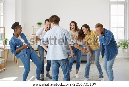 Multiracial friends meet up, enjoy free time and have fun together. Group of happy cheerful young diverse mixed race people laughing at a very good funny joke all together Royalty-Free Stock Photo #2216905109