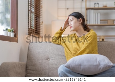 Depressed young Asian woman sitting on floor at home, Frustrated confused Sad female feels unhappy problem in personal life quarrel breakup with boyfriend or unexpected pregnancy concept Royalty-Free Stock Photo #2216946141