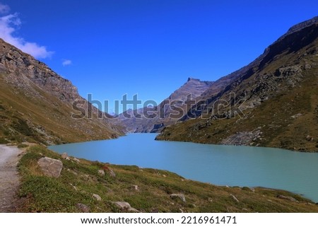 Mauvoisin reservoir located in Val de Bagnes, Valais with concrete arch dam, Switzerland, Europe Royalty-Free Stock Photo #2216961471