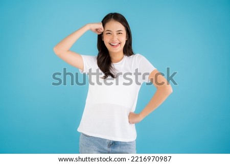 Beautiful Asian woman standing doing various poses on a blue background happy smile feel relaxed and fun.