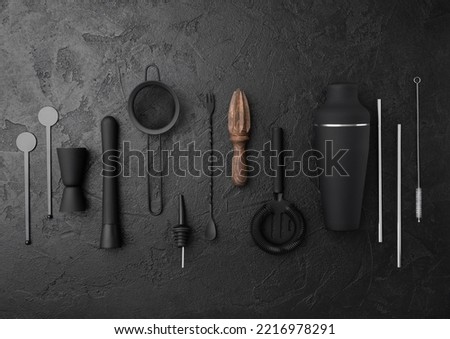 Various cocktail,bar utensils black matt steel set on black background.Shaker,strainer,spoon,jigger with silver straw and wooden juicer. Royalty-Free Stock Photo #2216978291