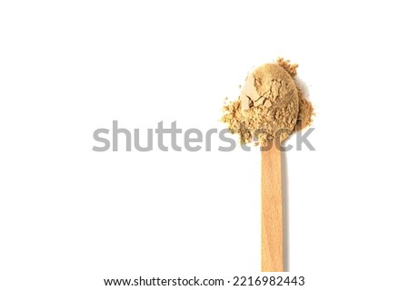 Top view of a spoon with raw maca root powder isolated on white Royalty-Free Stock Photo #2216982443