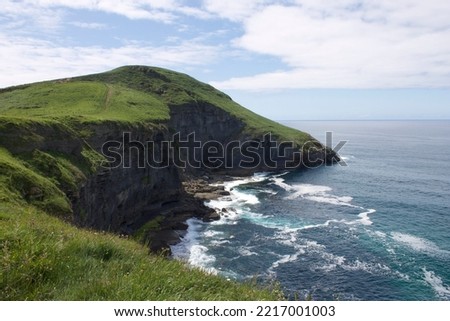 The beautiful cliffs in the North of Spain photographed while traveling in a camper van, shot during the day, beautiful ocean image with green hills on which you can walk. Background adventure picture