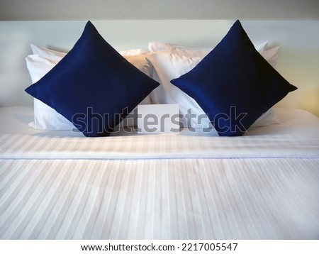 Blank greetings card at the Dark Blue Pillow on the bed with Hotel turn down service