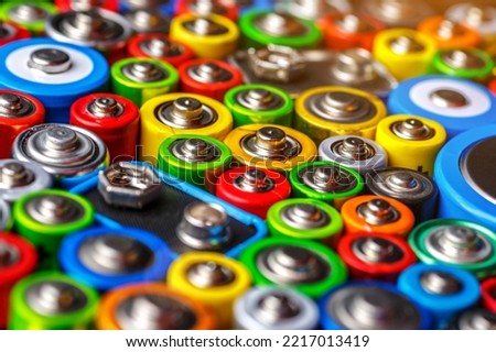 Energy abstract background of colorful batteries.Old used batteries ready for recycling.Used batteries from different manufacturers, waste, collection and recycling,Alkaline battery aa size. Royalty-Free Stock Photo #2217013419