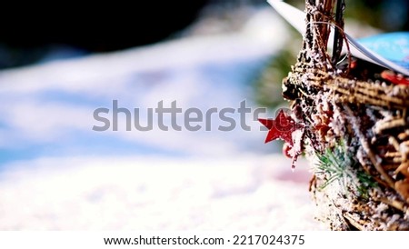 close-up, Christmas toys hanging on a snow-covered Christmas tree branch. winter, frosty, snowy, sunny day. High quality photo