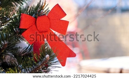 close-up, Christmas toys hanging on a snow-covered Christmas tree branch. winter, frosty, snowy, sunny day. High quality photo
