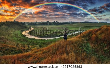 Woman Looking At Rainbow. rainbow over the river. nature of Ukraine