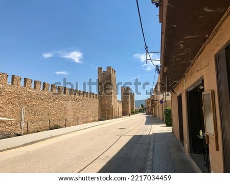 Montblanc, Spain, June 2019 - A brick building with a sign on the side of a road