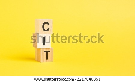 word CIT on wooden cubes, business concept. copy space.