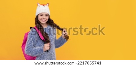 teen girl in knitwear on yellow background. portrait of child wearing warm clothes. Banner of school girl student. Schoolgirl pupil portrait with copy space.