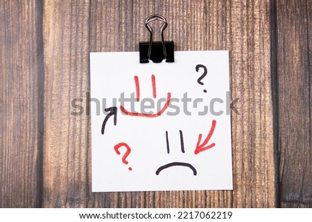 The emotional emoticons sad and cheerful with arrows.Change and mood swings. Royalty-Free Stock Photo #2217062219