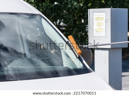 A man cleans his car window 