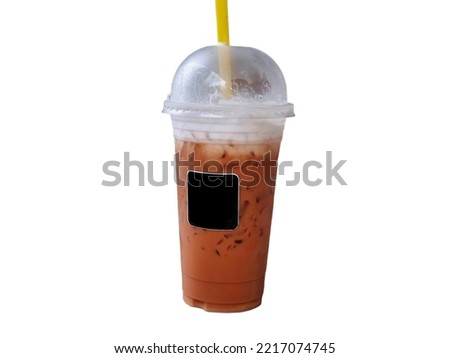 ice Thai milk tea with foam milk on the top in plastic glass. isolate white background.