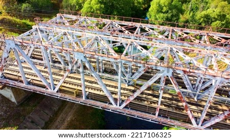 railway bridge over a small river close-up view from above, bright colorful photo. High quality photo