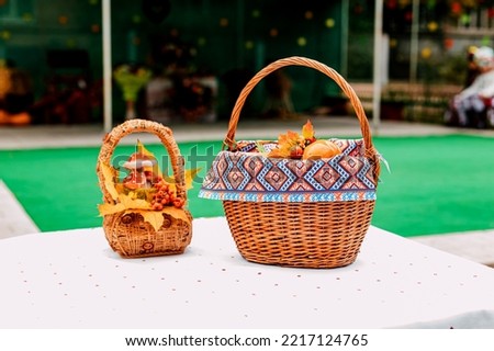 Autumn composition baskets with autumn leaves and berries stand on a white table