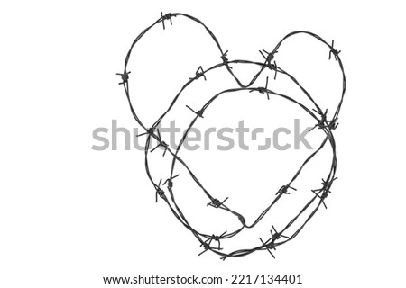 Barbed wire in the form of a heart on a white isolated background, Royalty-Free Stock Photo #2217134401