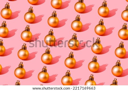 christmas ball gold pattern on light pink background. High quality photo