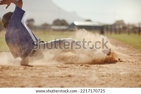 Baseball, baseball player running and diving for home plate in dirt during sport ball game competition on sand of baseball pitch. Sports man, ground slide and summer fitness training at Dallas Texas