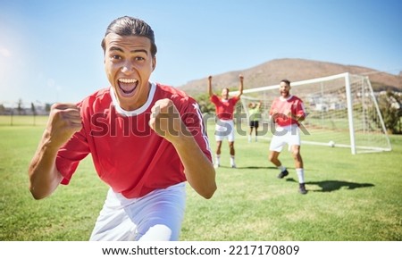 Soccer player, celebrate and winning team with fist in celebration of scoring goal for sport match, game or competition with success gesture. Victory and fun with men training on football field Royalty-Free Stock Photo #2217170809