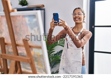 Young african american woman artist smiling confident making picture at art studio