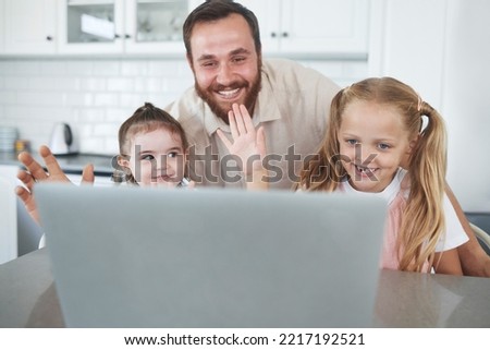 Laptop, video call and happy father with kids wave at digital device screen together in kitchen. Smiling children, talking and virtual cyber conversation communication during lockdown on digital pc