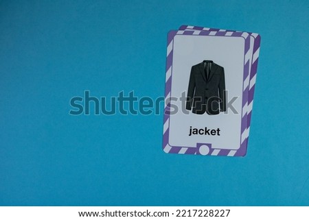 Flashcard with jacket photo placed on the right above a blue background.