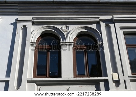 a fragment of a historical building with two arched windows
