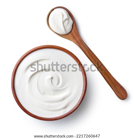 Brown ceramic bowl and wooden spoon of fresh sour cream isolated on white background, top view Royalty-Free Stock Photo #2217260647