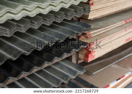Well stocked supplies of 8x4 plywood sheets and Corrugated GI (Galvanized Iron Sheets) at a hardware store.