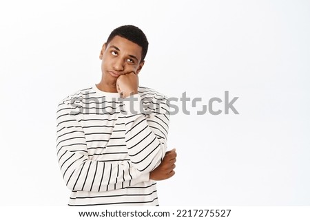 Bored african american man looking annoyed, unamused and uninterested, standing over white background