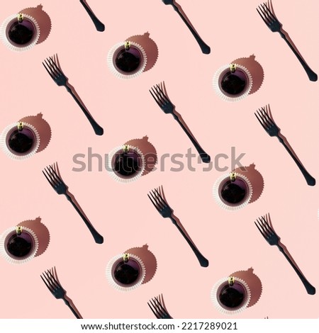 Retro style forks and creative cupcakes, dark Christmas baubles. Aesthetic layout on a candy pink background, gothic party idea. 