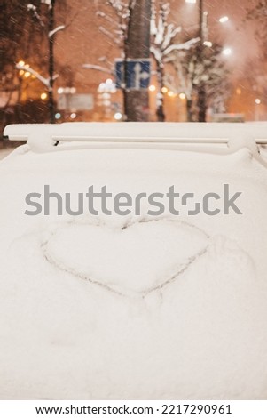 draw a heart on white snow