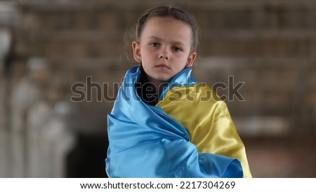 Portrait of a sad girl with a flag of Ukraine. A request to stop aggression on the part of Russia