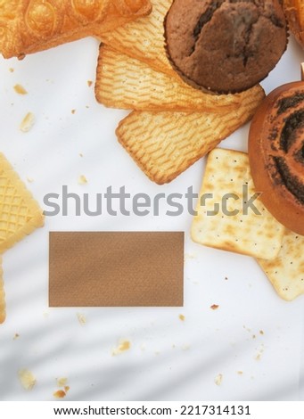 Bright pastries on a white backdrop, flat lay template with empty business card